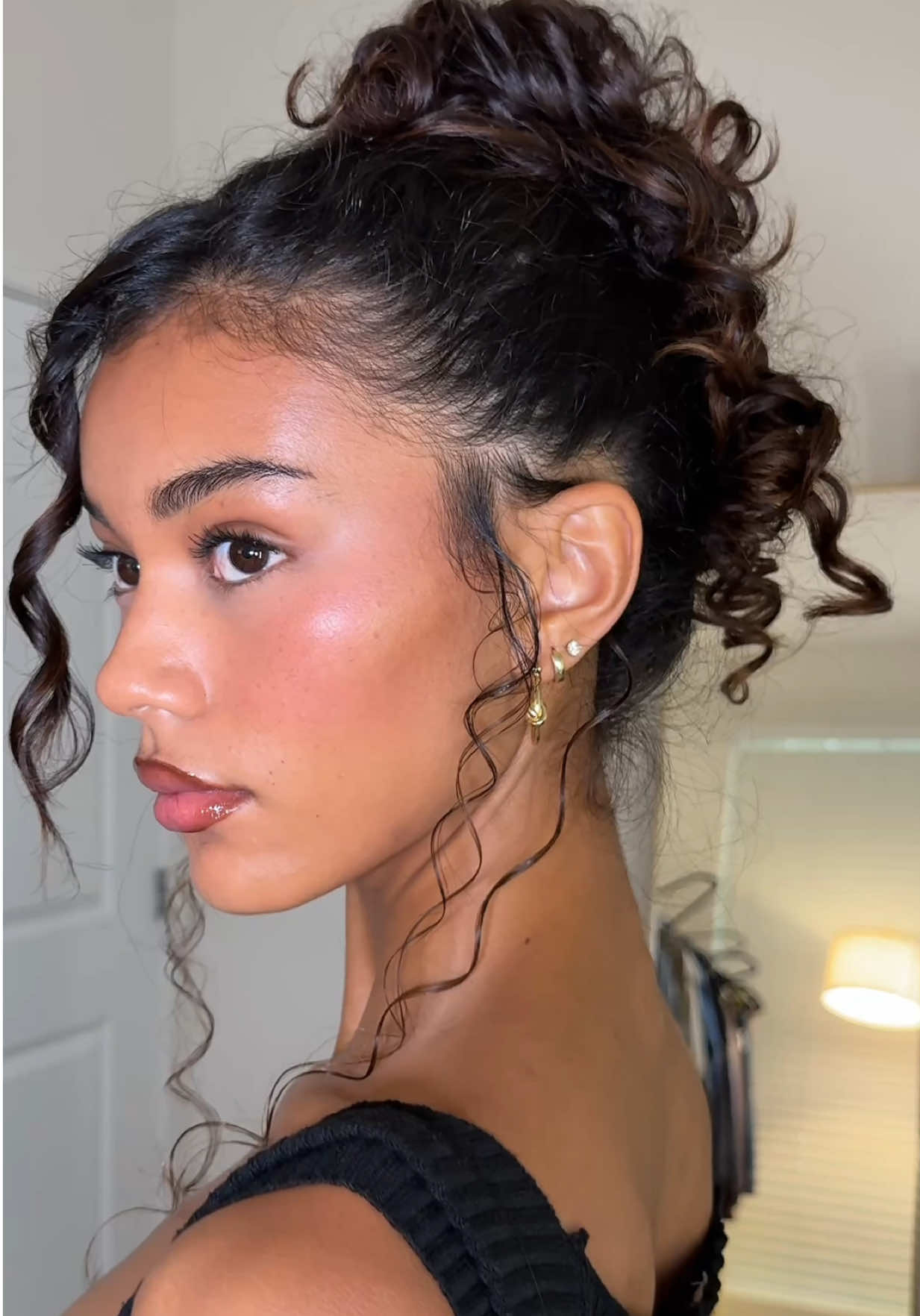 TikTok post by @itsmikaylanicolee for OLAPLEX. Caption reads: Easy updo for the curly girls🕯️🤍 I love using....