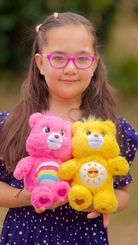 Instagram post by @little_amaya_in_wonderland for Care Bears. Caption reads: #AD Care Bears magic in the palm of your hand!....
