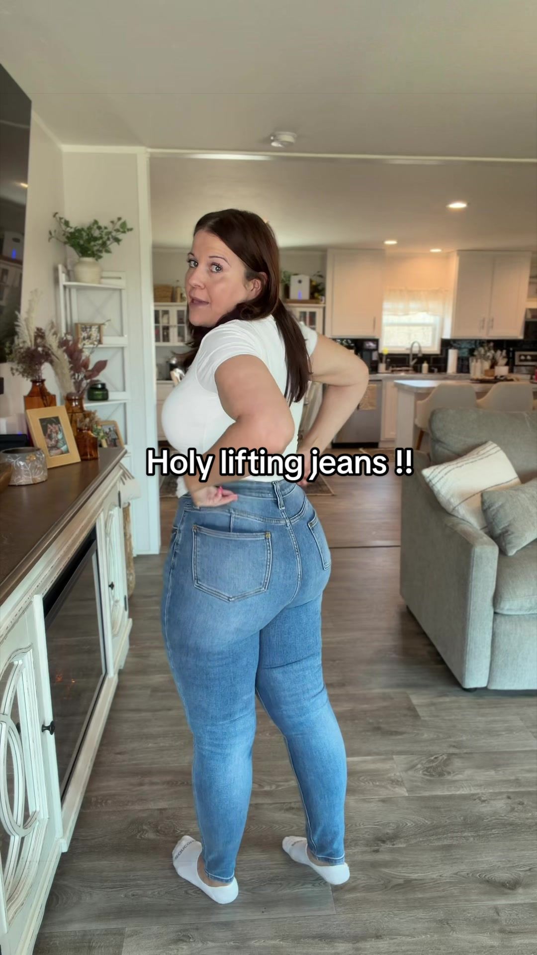 TikTok post by @catshrank for Emma Lous Boutique. Caption reads: The lift in these jeans from @Emma Lous Boutique....