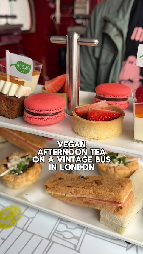 Instagram post by @maggieeatsvegan for Brigit’s Bakery. Caption reads: Vegan afternoon tea on a vintage bus in London....