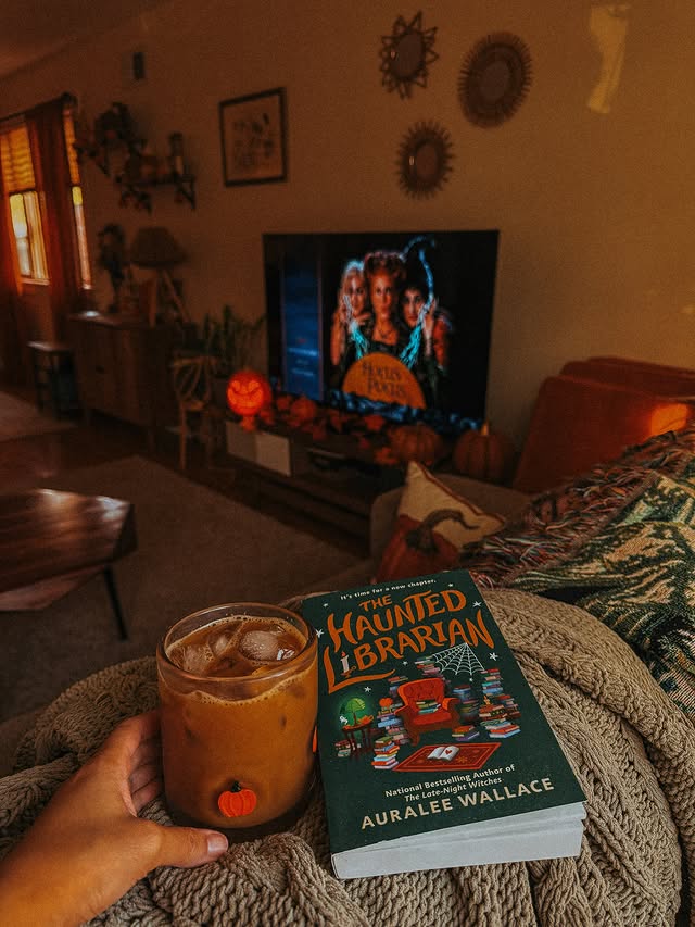 Instagram post by @book__skywalker for Berkley Publishing Group. Caption reads: Coffee & currently reading: THE HAUNTED LIBRARIAN....