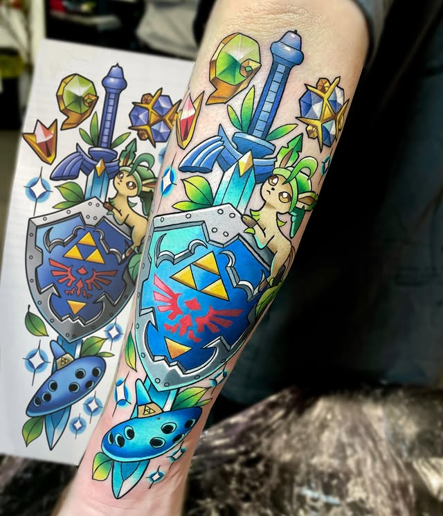Instagram post by @deadpan_anne_tattoo for Barber DTS Tattoo Supplies. Caption reads: 💙Ocarina Sword💙 with Leafeon of course 🥰🍃....