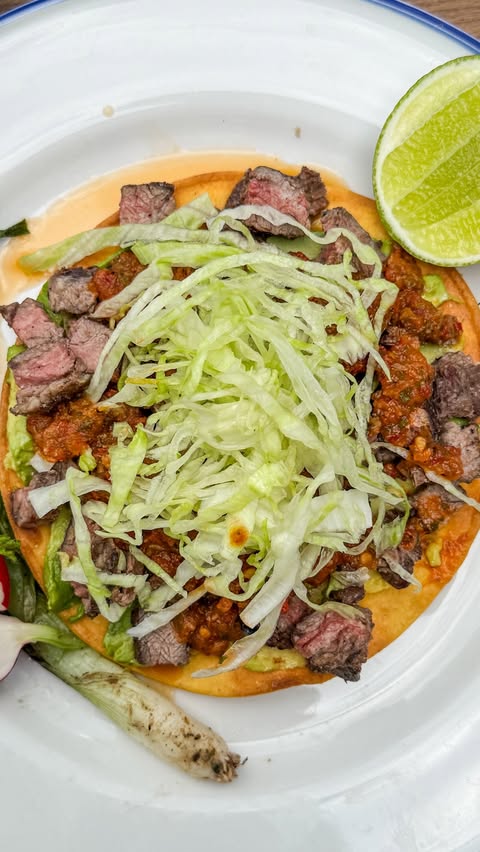 Instagram post by @primal_gourmet for Kettle & Fire. Caption reads: Carne Asada Tostadas with Chipotle Salsa… smoky,....