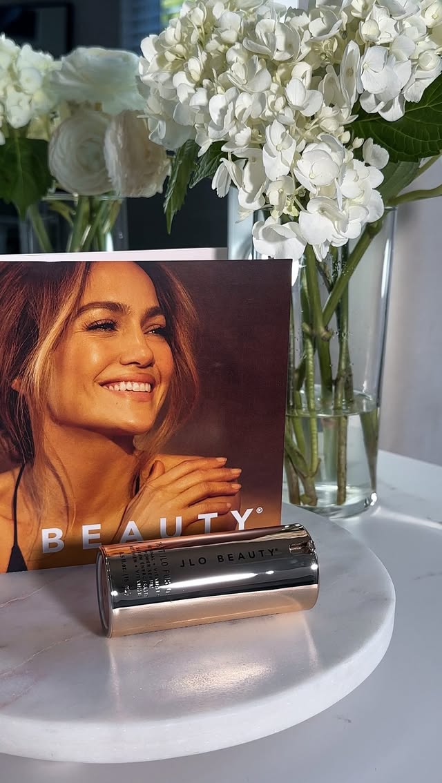 Instagram post by @katevinnik.ugc for JLO BEAUTY. Caption reads: [...] tonight, a brighter glow tomorrow ✨....