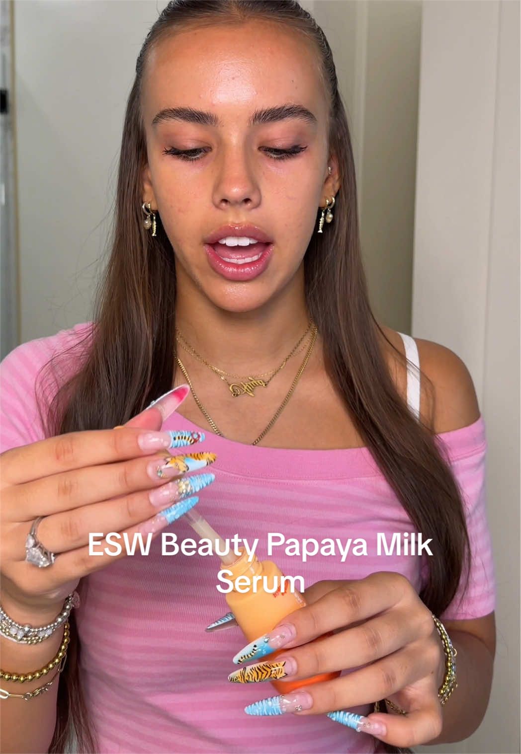TikTok post by @only1aliya for ESW Beauty. Caption reads: need 14 of these rn @ESW Beauty #papayamilk #serum.