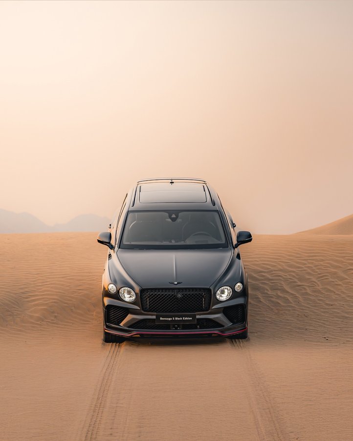 Instagram post by @a7mdjam for Bentley Motors. Caption reads: Born for the city. Perfect in the dunes.....
