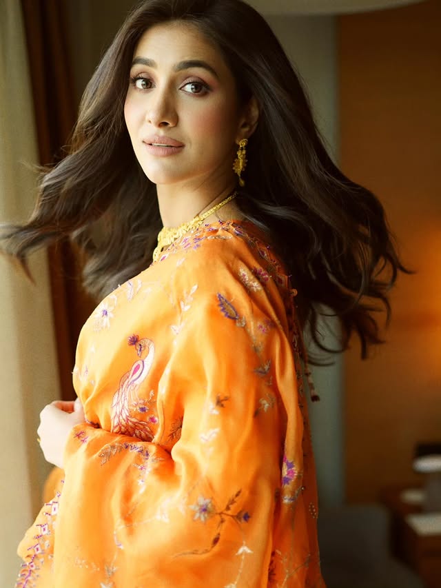 Instagram post by @rukminimaitra for Malabar Gold and Diamonds. Caption reads: 🧡 🙃 @malabargoldanddiamonds #RukminiMaitr.