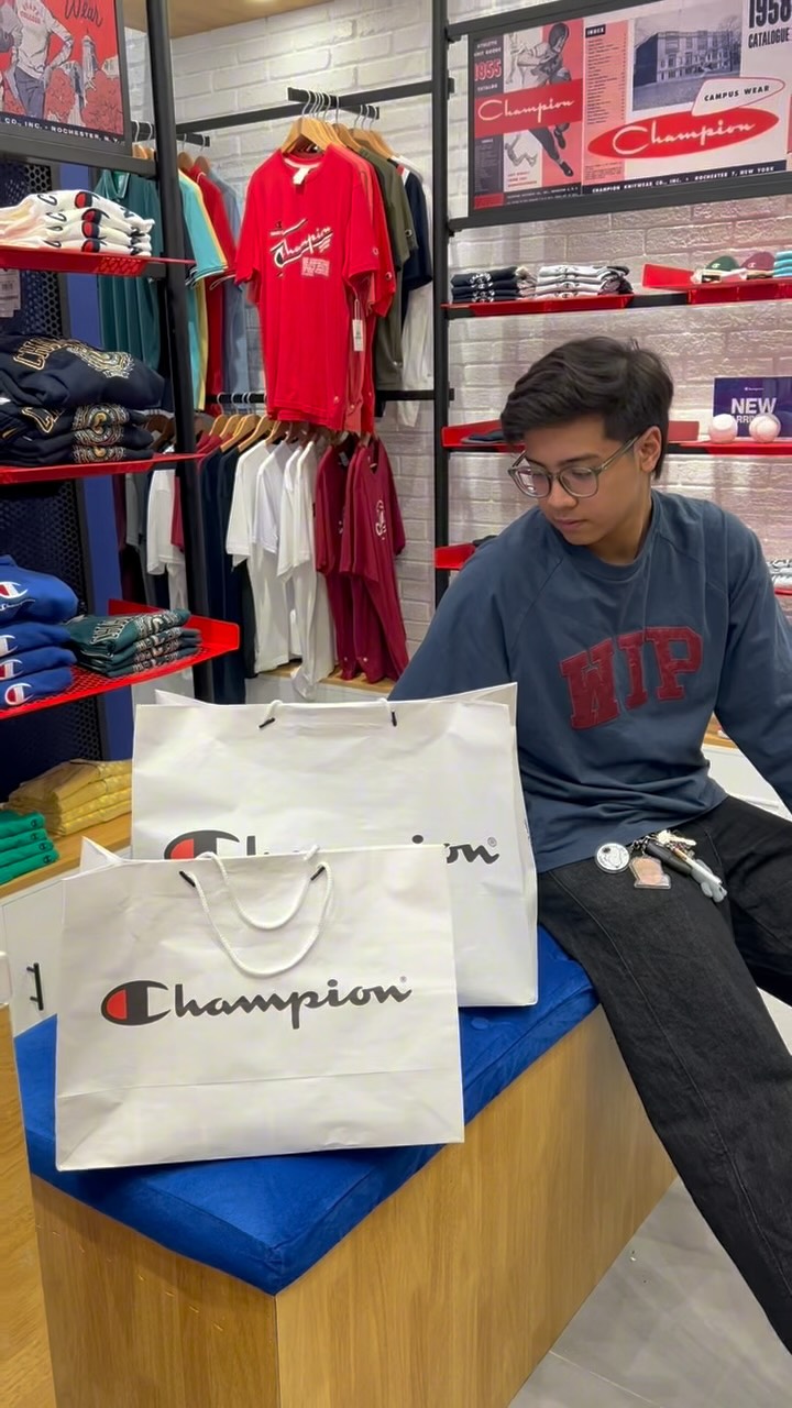 Instagram post by @louiseabuel for Champion. Caption reads: Hey champs! @champion.ph is now open at SM City....