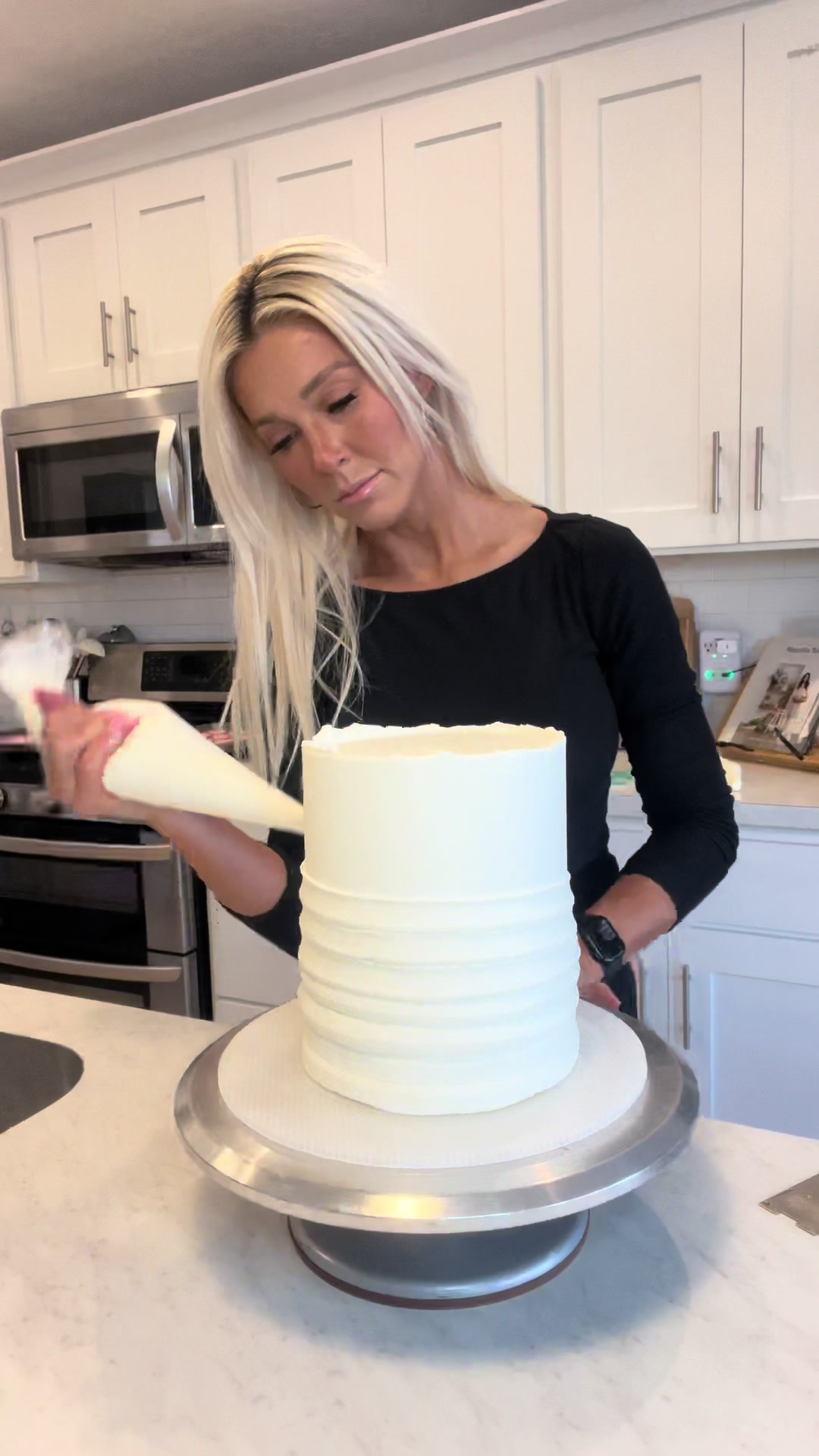 TikTok post by @theblondewhobakes for Chefmaster. Caption reads: Part 2: Decorating the cake  This cake was for a....