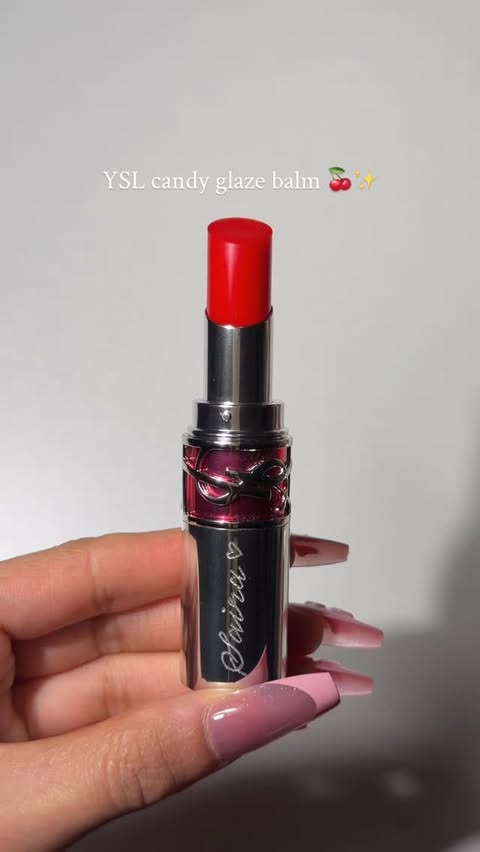 Instagram post by @sairasglam for Shoppers Drug Mart. Caption reads: @yslbeauty candy glaze balm 🍒 Such a pretty balm....