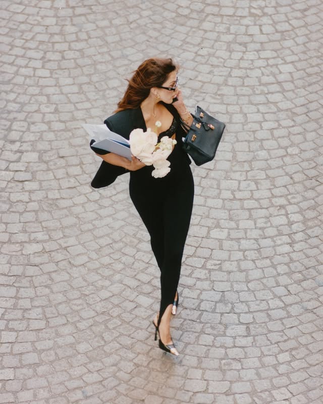 Instagram post by @irismittenaere for Intimissimi. Caption reads: Busy in the city with @intimissimi 🖤....