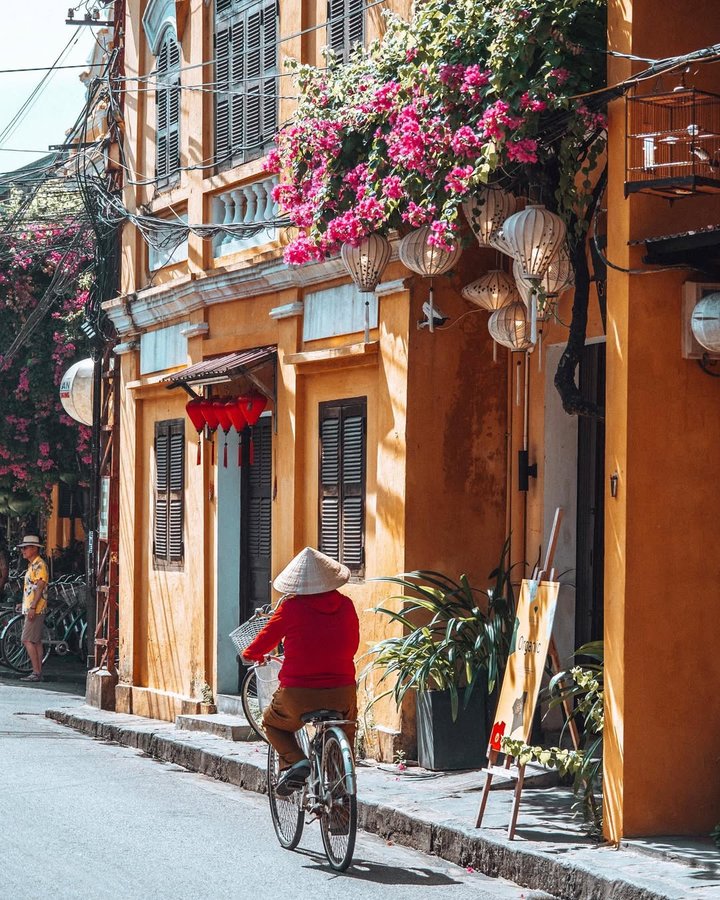 Instagram post by @bethsandland for Passion Passport. Caption reads: #TRAVELWITHBETH to Hoi An, Vietnam 🇻🇳🚲
—
[#AD]....