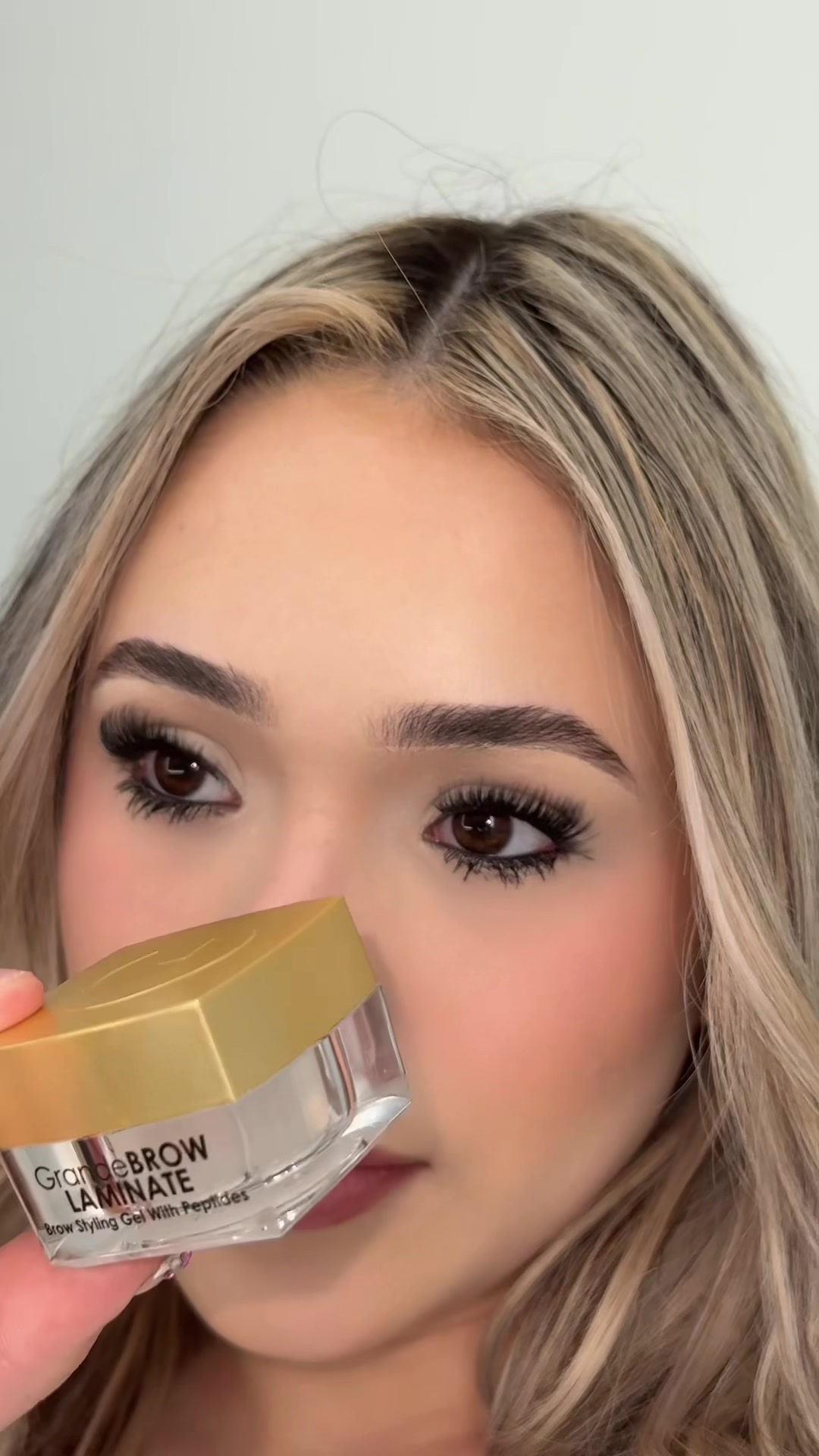 TikTok post by @melaxlani for Grande Cosmetics. Caption reads: the grandebrow laminate gel is my new go-to for my....
