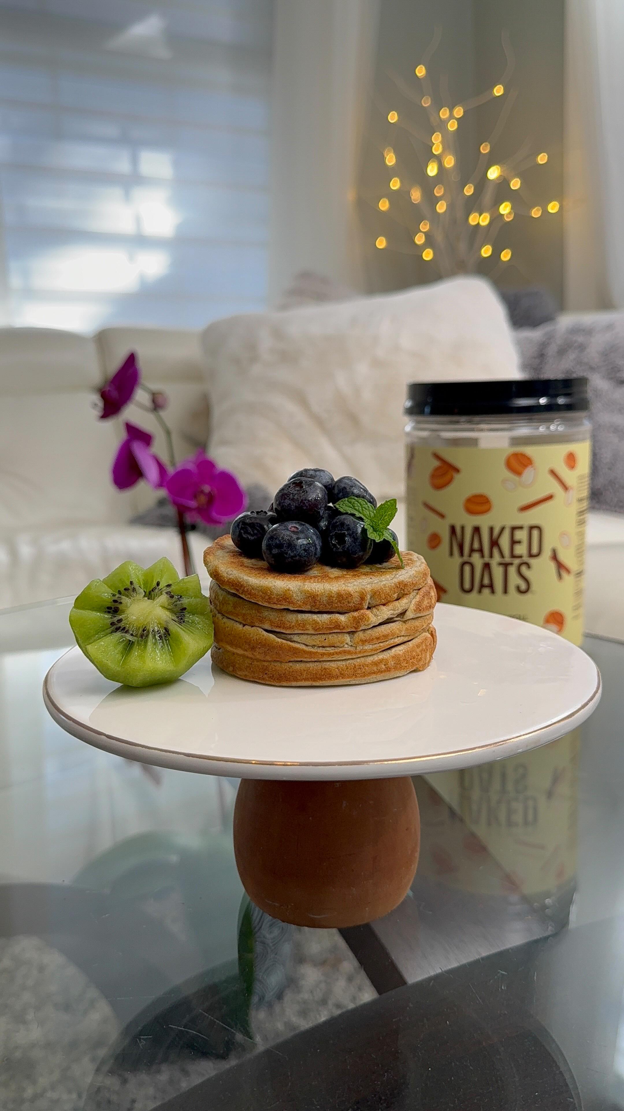 Instagram post by @lifestylebyanju for NAKED nutrition. Caption reads: [...] These pancakes made with @nakednutrition....