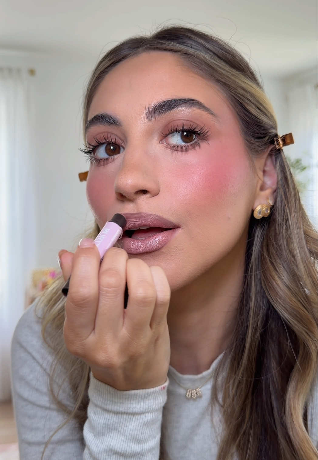 TikTok post by @samanthaa.nicole for Burt's Bees USA. Caption reads: My two @burtsbeesUSA essentials I’d recommend....