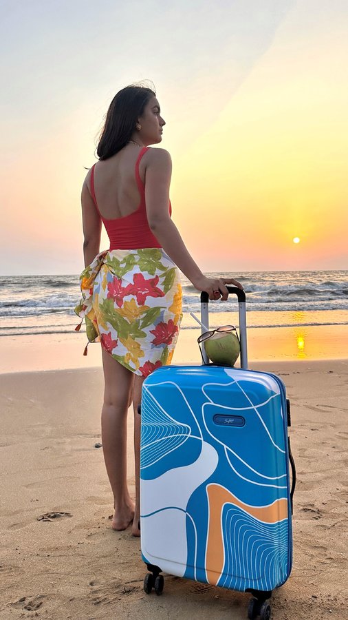 Instagram post by @yashisingh___ for Skybags. Caption reads: 🐚Sippin’ coconuts, soakin’ sunsets, and rollin’....