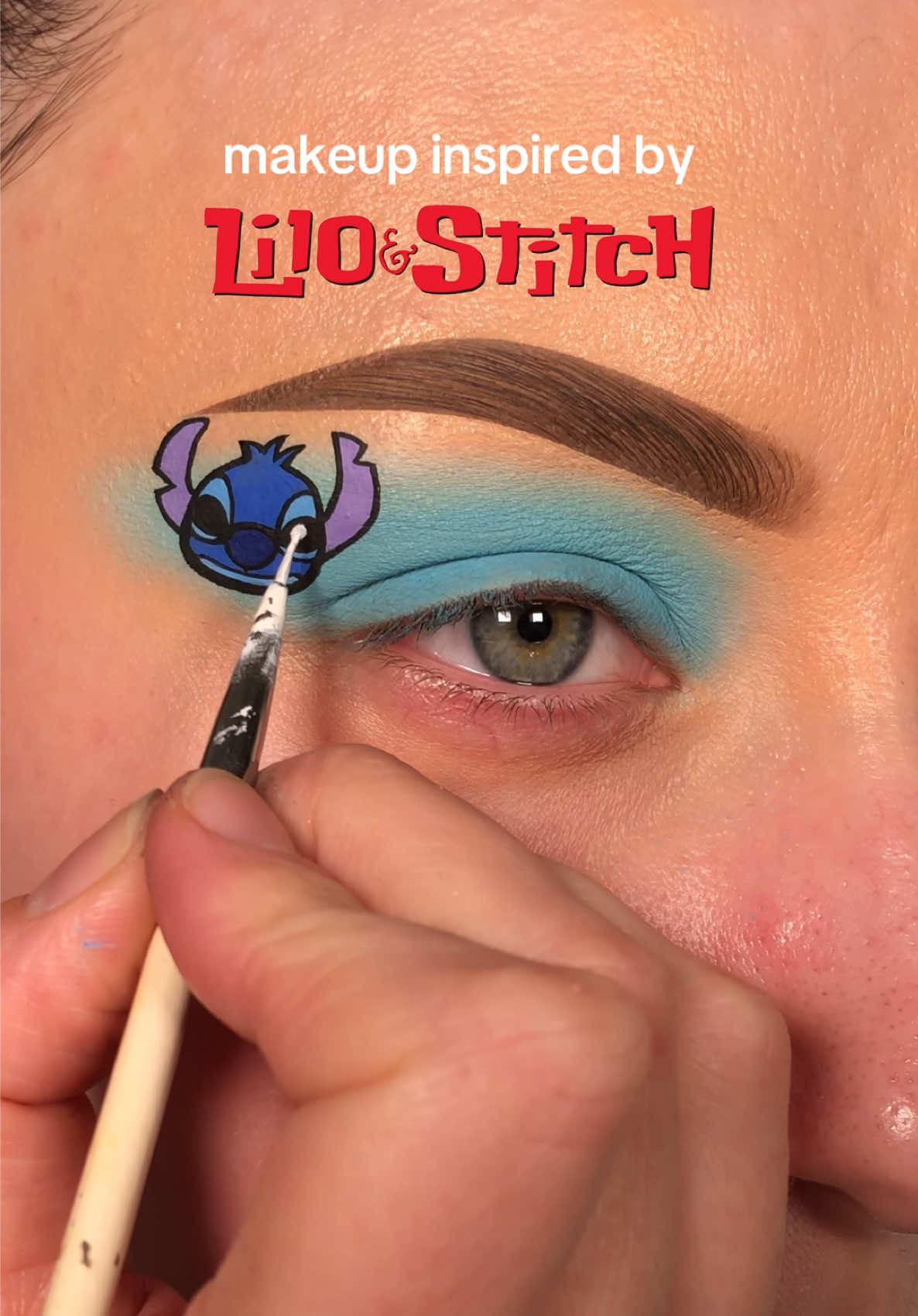 TikTok post by @alicekingmakeup for Disney Animation. Caption reads: makeup inspired by lilo & stitch - stitch💙🛸 -  -....