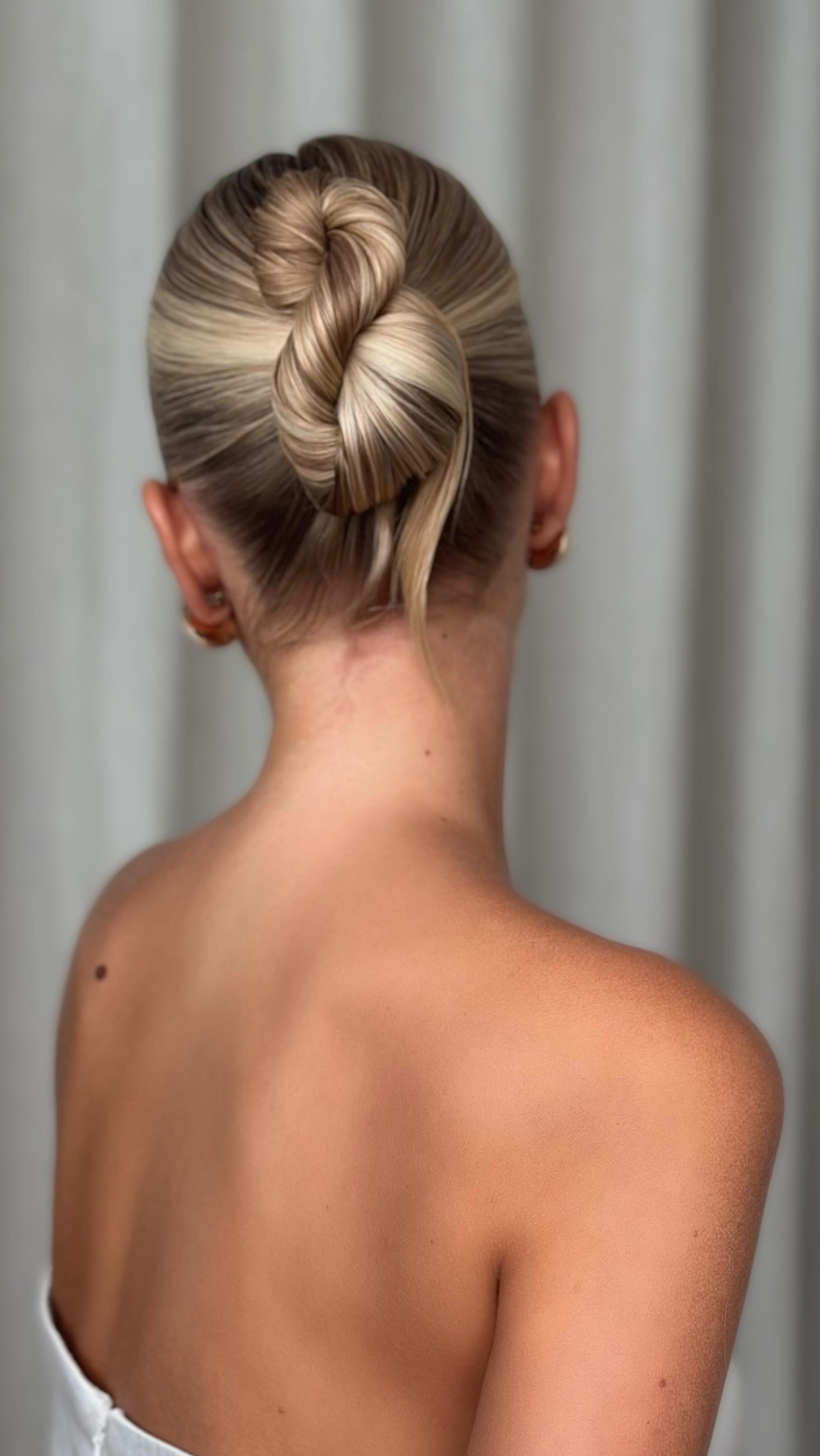 Instagram post by @kasia_fortuna for Moroccanoil. Caption reads: The Figure 8 Sleek Bun looks simple—but getting....