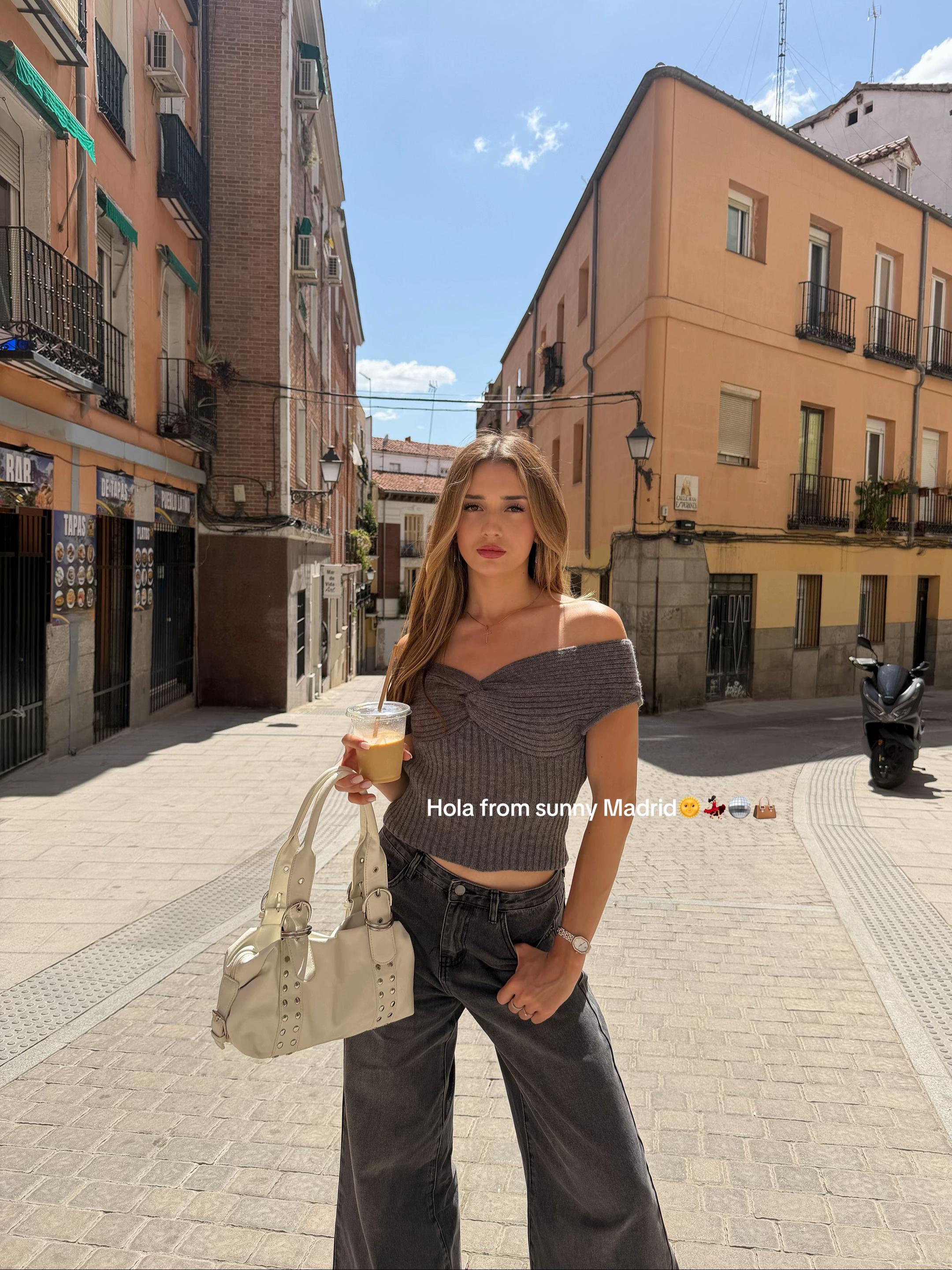 TikTok post by @zhanessss for Cider. Caption reads: Hola from sunny Madrid🌞💃🏻🪩👜 wearing @Cider🎀✨....