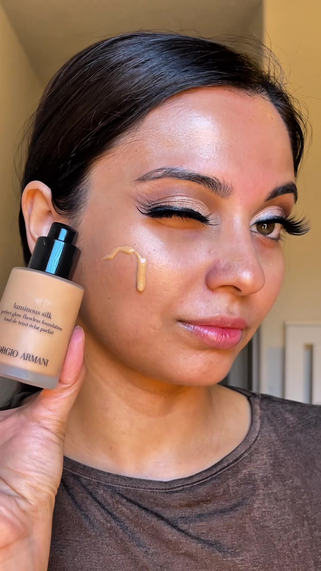 TikTok post by @maishamouu for BASMA Beauty. Caption reads: #armanibeauty luminous silk foundation gave me....