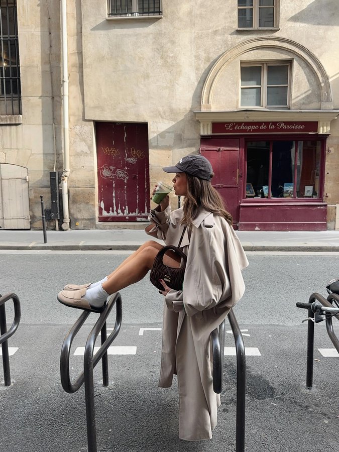 Instagram post by @capucinerqllrt for Source Unknown. Caption reads: this trench is everything.