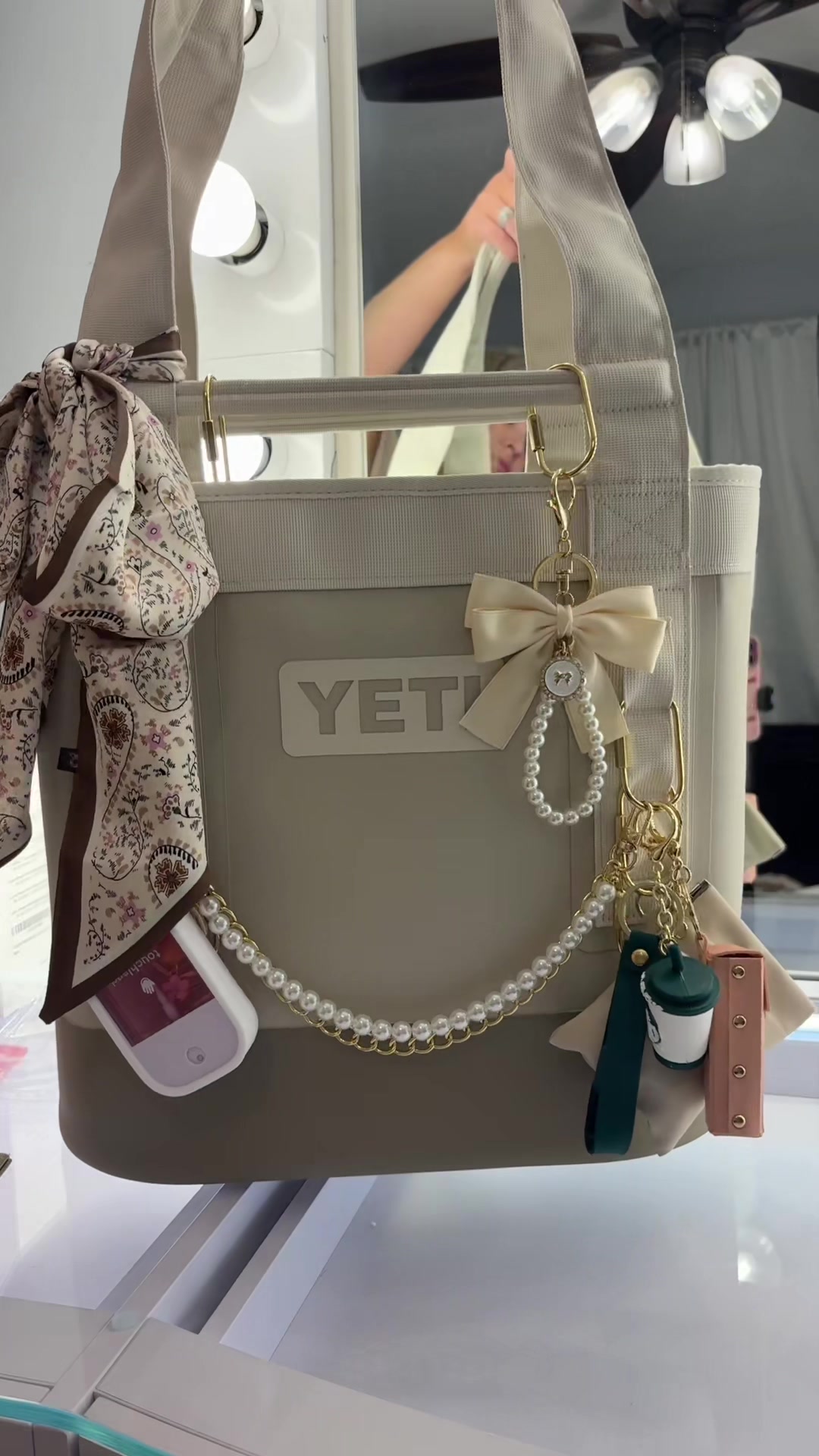 TikTok post by @makeupbykristenowilliams for Touchland. Caption reads: Literally obsessed with this bag! @YETI @touchland....