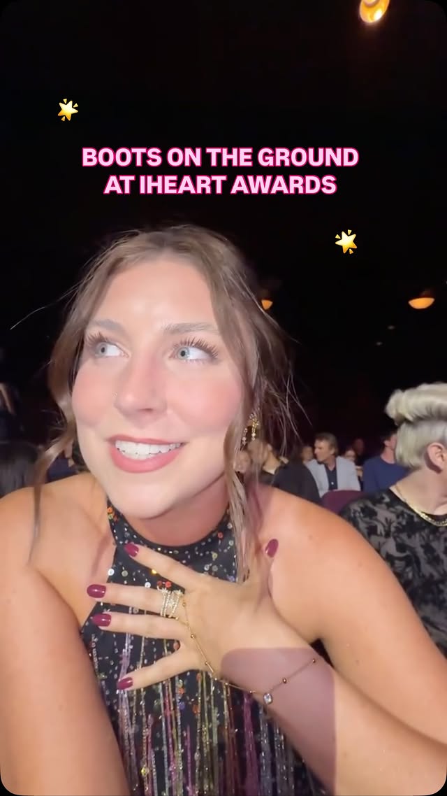 Instagram post by @reagan.baylee for iHeartRadio. Caption reads: TRAVIS IS HERE 😭😭 #FOXPartner I’M AT....