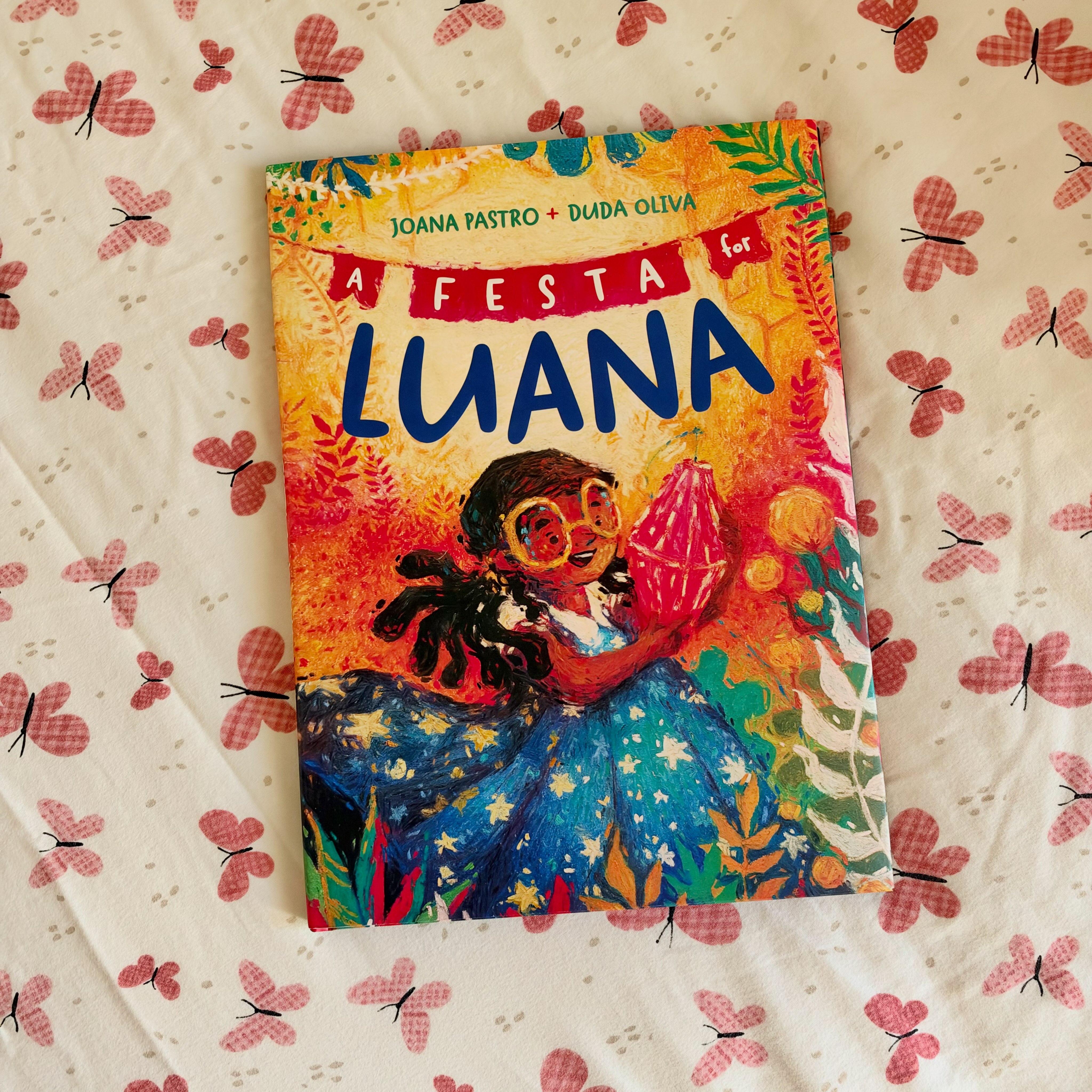 Instagram post by @threelittleloveslibrary for Simon Kids. Caption reads: A Festa for Luana Luana is so excited, she and her....