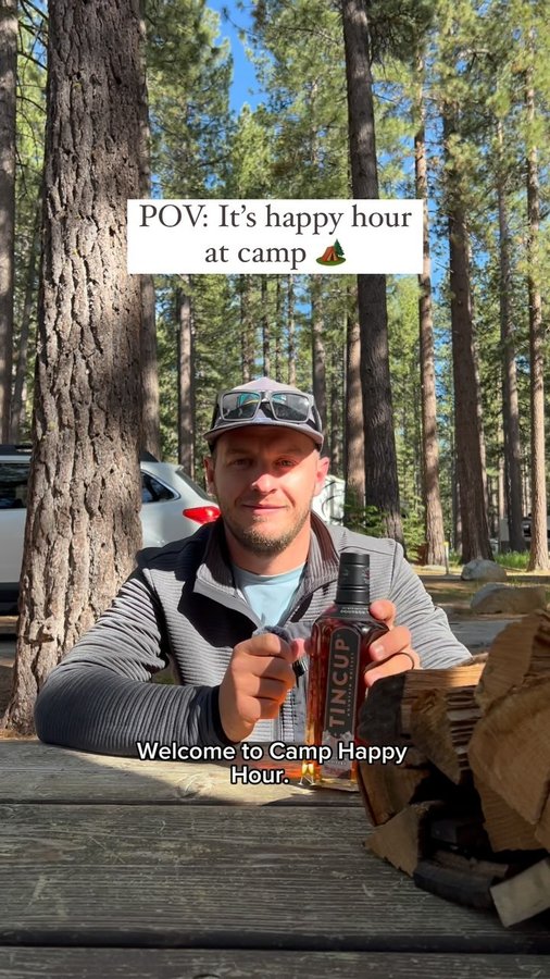 Instagram post by @the_adventureaddicts for TINCUP Whiskey. Caption reads: the best kind of happy hour 🏕️ 👇🏼

We are....