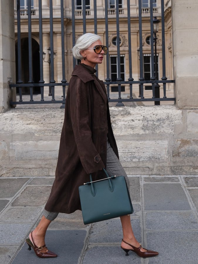 Instagram post by @greceghanem for Strathberry. Caption reads: On the go between meetings in Paris, my....