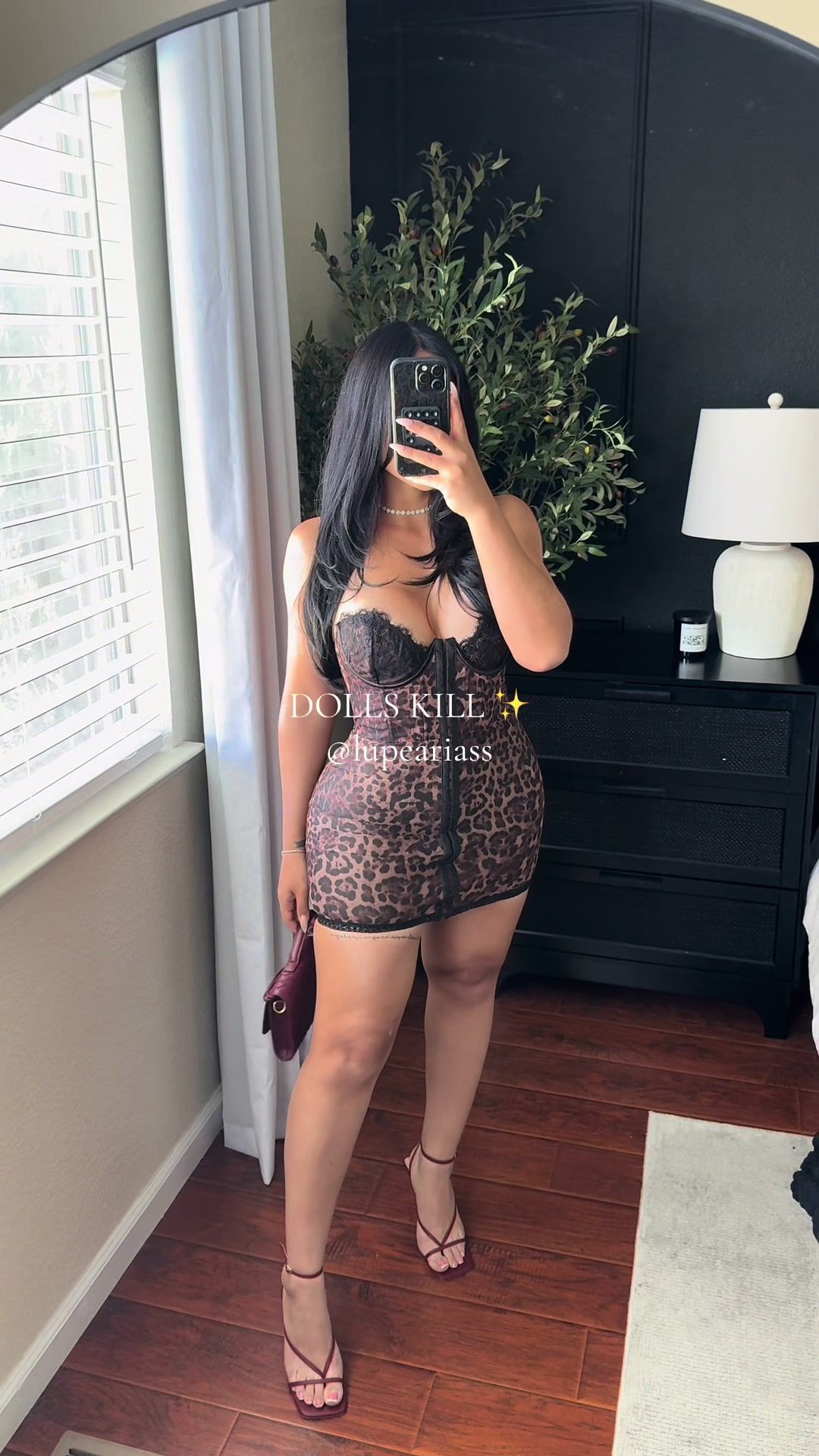 TikTok post by @lupeariass for Dolls Kill. Caption reads: @Dolls Kill 🐆🖤✨ #dollskill #minidress #fyp #fypシ....