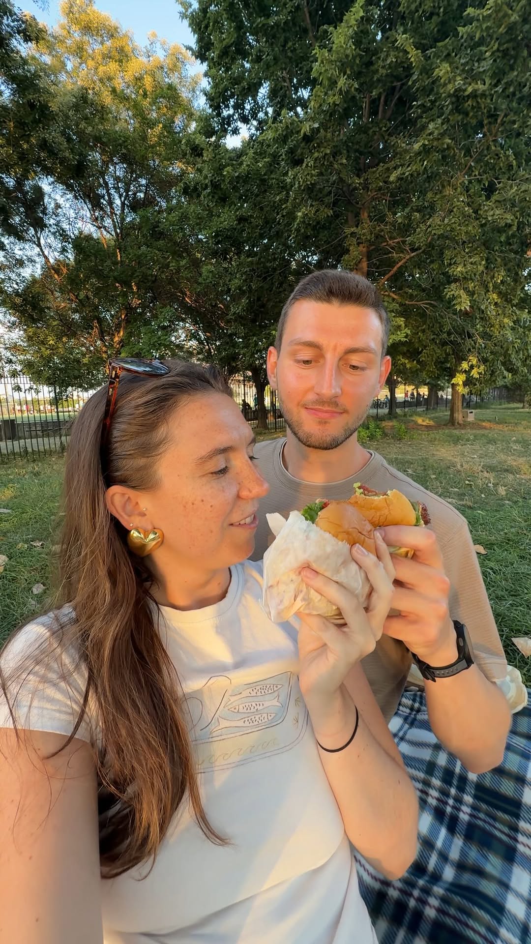 Instagram post by an influencer for Shake Shack. Caption reads: Our @shakeshack picnic spreadddddd! 🍔🍟🥤🧺 [...].