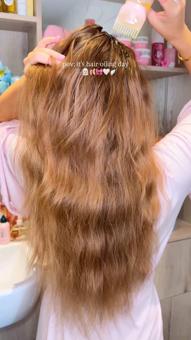 Instagram post by @byemmaleah for Cocoandeve. Caption reads: pov: it’s hair oiling day....