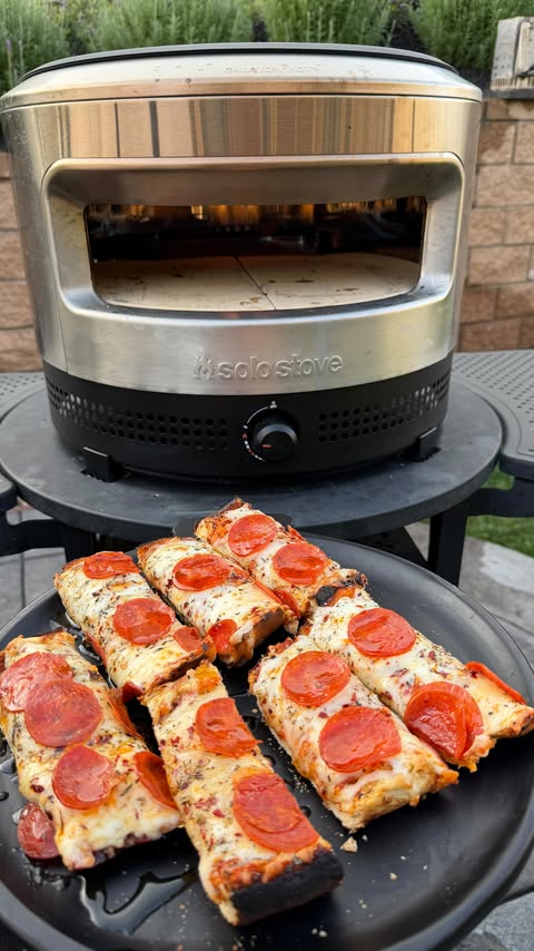 Instagram post by an influencer for Solo Stove. Caption reads: Put the new @solostove Pi Prime Pizza Oven to work....