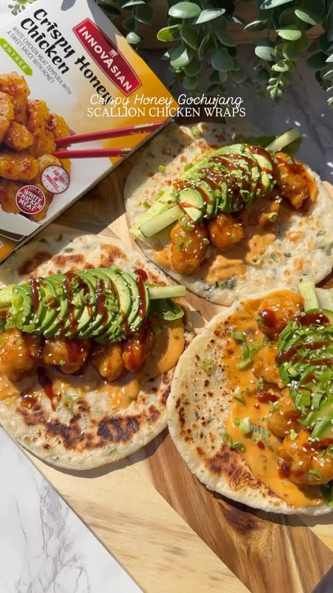 Instagram post by @shewillevolve for InnovAsian Cuisine. Caption reads: Honey Gochujang Chicken Scallion Wraps🔥 They're....