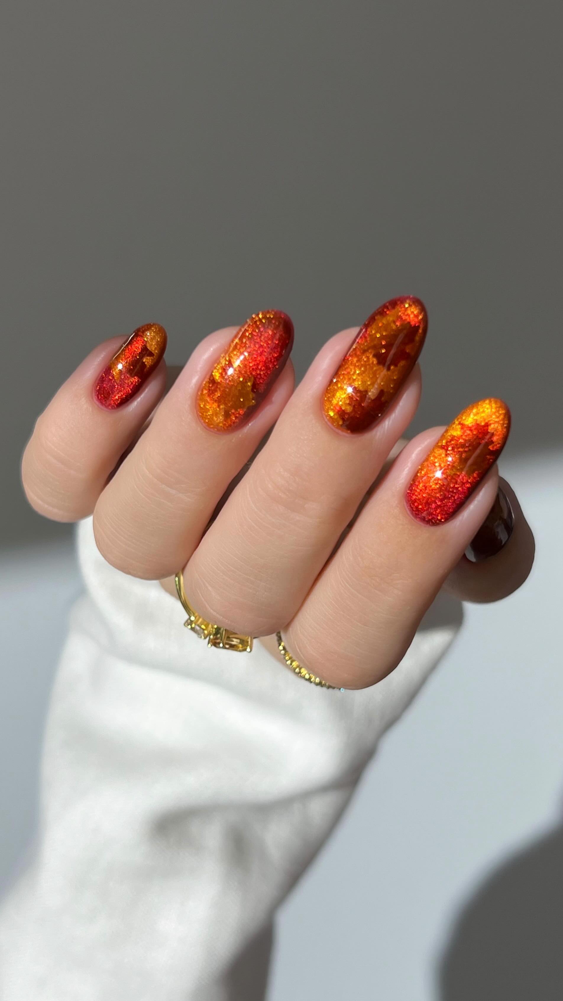 Instagram post by @heygreatnails for Modelones. Caption reads: 🍁✨ catch me crunching sparkly maple leaves with....