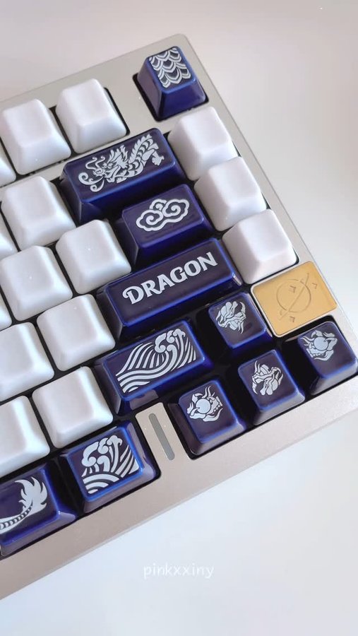 Instagram post by @pinkxxiny for Cerakey. Caption reads: dragon novelty ceramic keycaps 🐉....