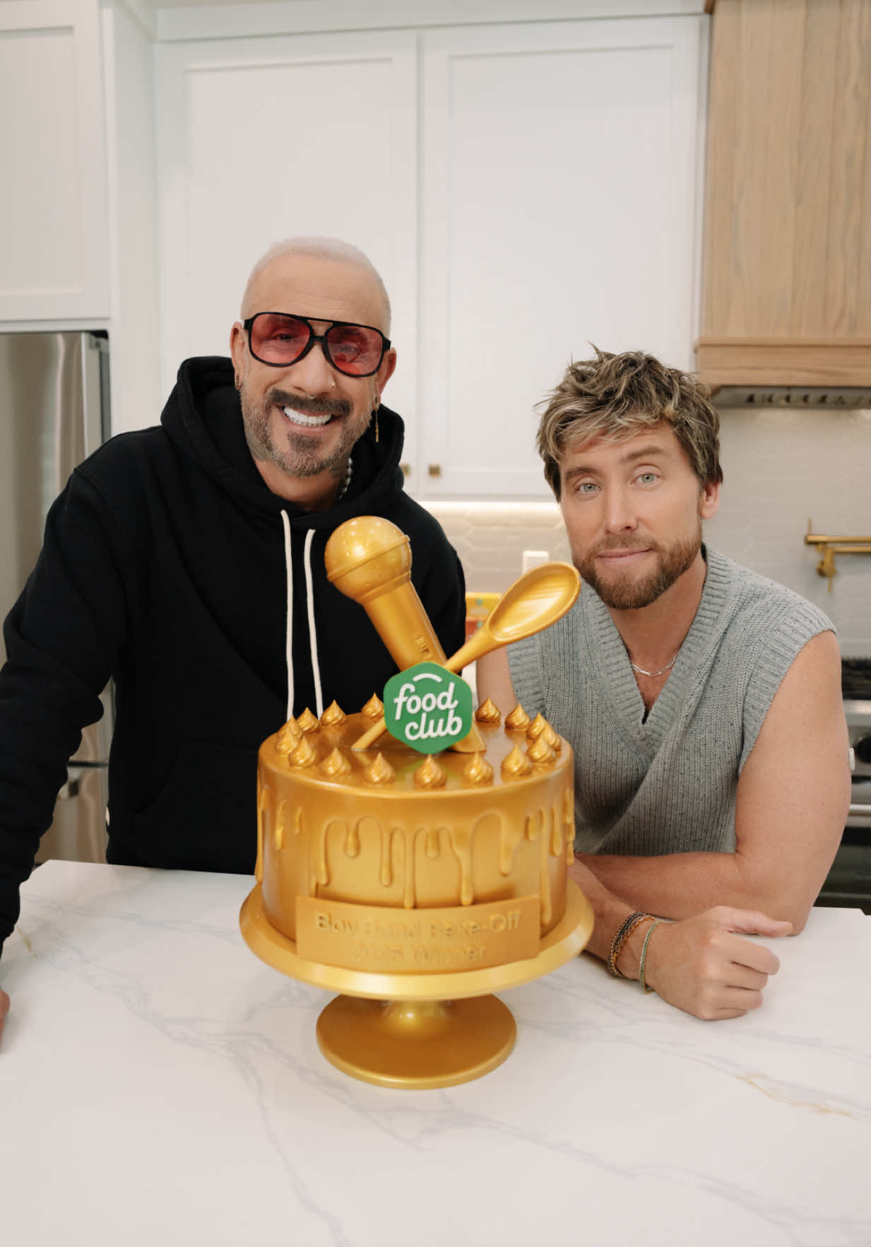 TikTok post by @lancebass for Feeding America. Caption reads: AJ and I faced off in the ultimate Boyband Bakeoff....