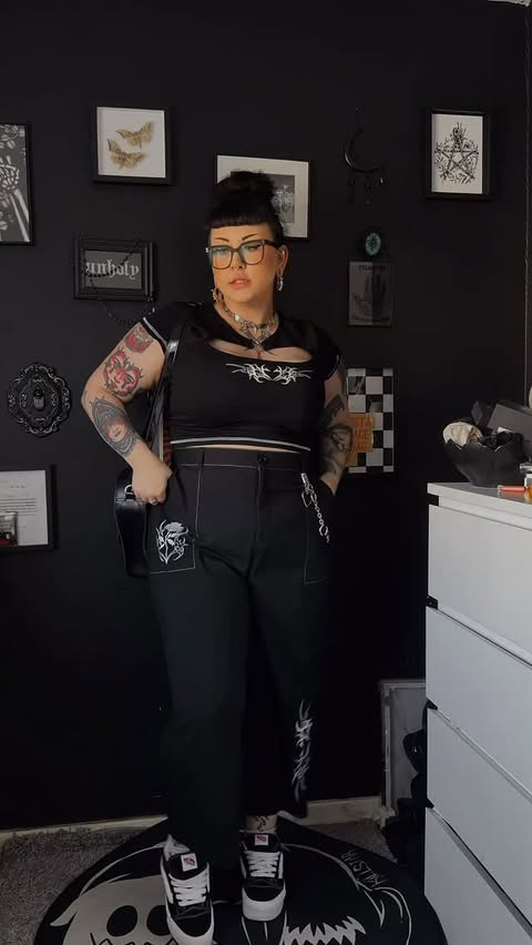 Instagram post by @rhikatera for Hell Bunny. Caption reads: [...] of this outfit 🌚🖤 Trousers & top:....