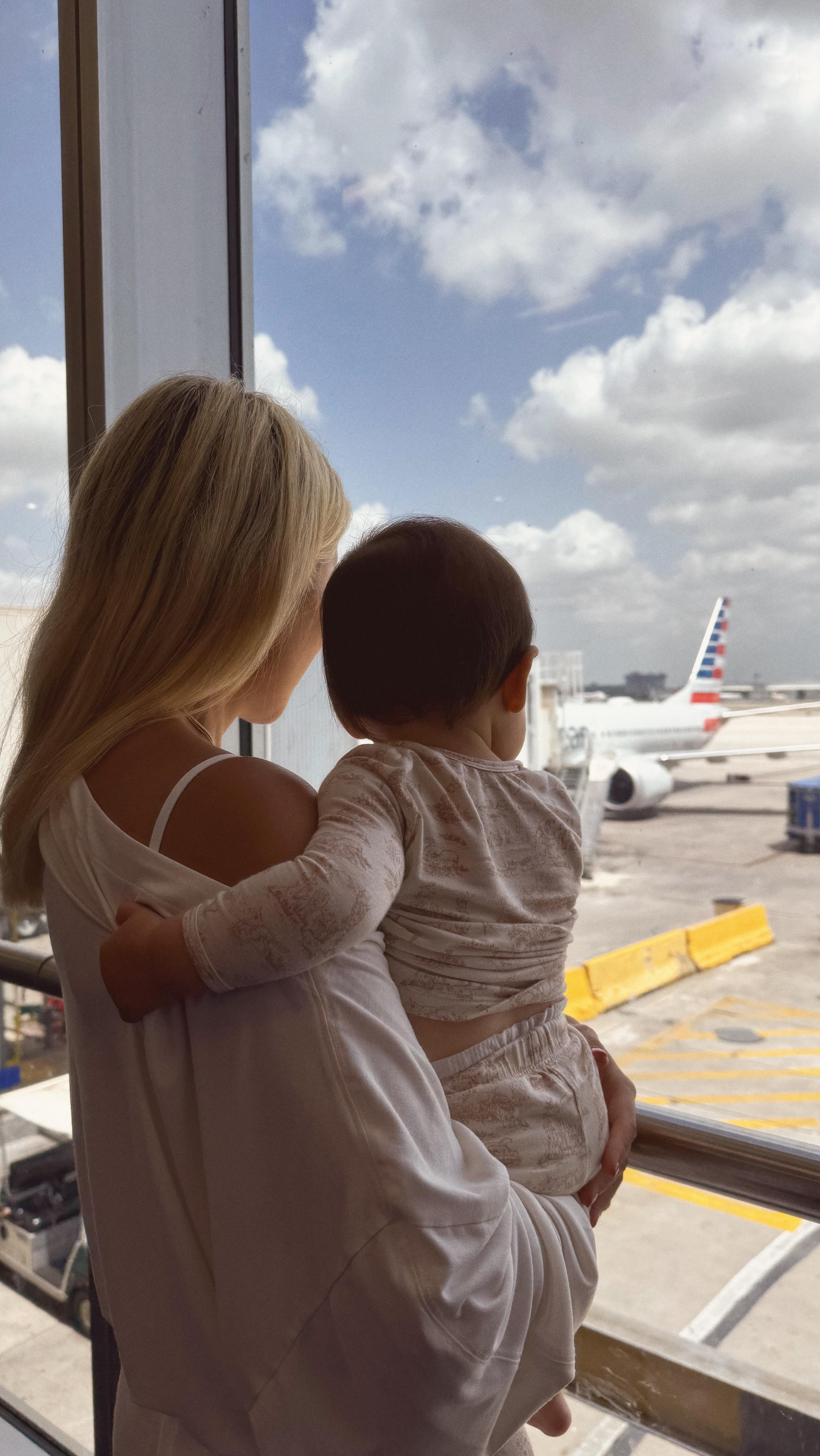 Instagram post by @rrayyme for American Airlines. Caption reads: 1ST INTL TRAVEL DAY!🥰✈️

From sneaking Opie out....