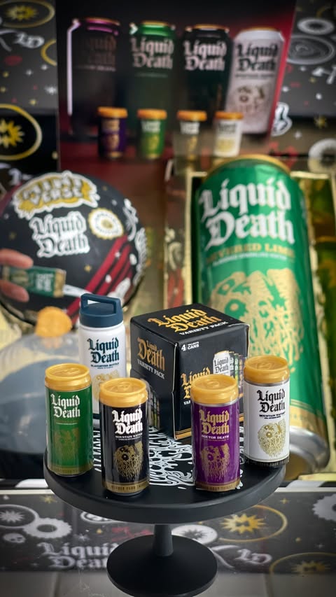 Instagram post by @disneysweetstuff for Liquid Death. Caption reads: [...] 5/21!!! 👈🏻 @officialminiverse @liquiddeath....