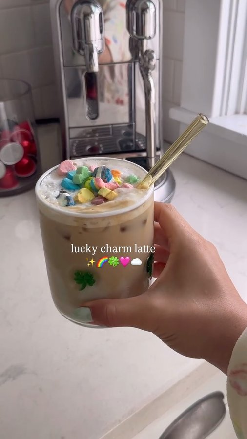 Instagram post by @foodtherapywithmeg for nutpods. Caption reads: lucky charm latte ✨🌈🍀🩷☁️ 

ingredients 
2 shots....