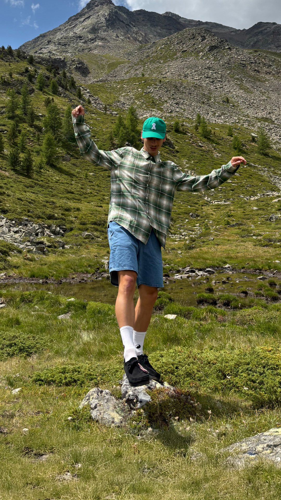 Instagram post by @jaylungo for ARMEDANGELS. Caption reads: Spend summer high up in the mountains in south....