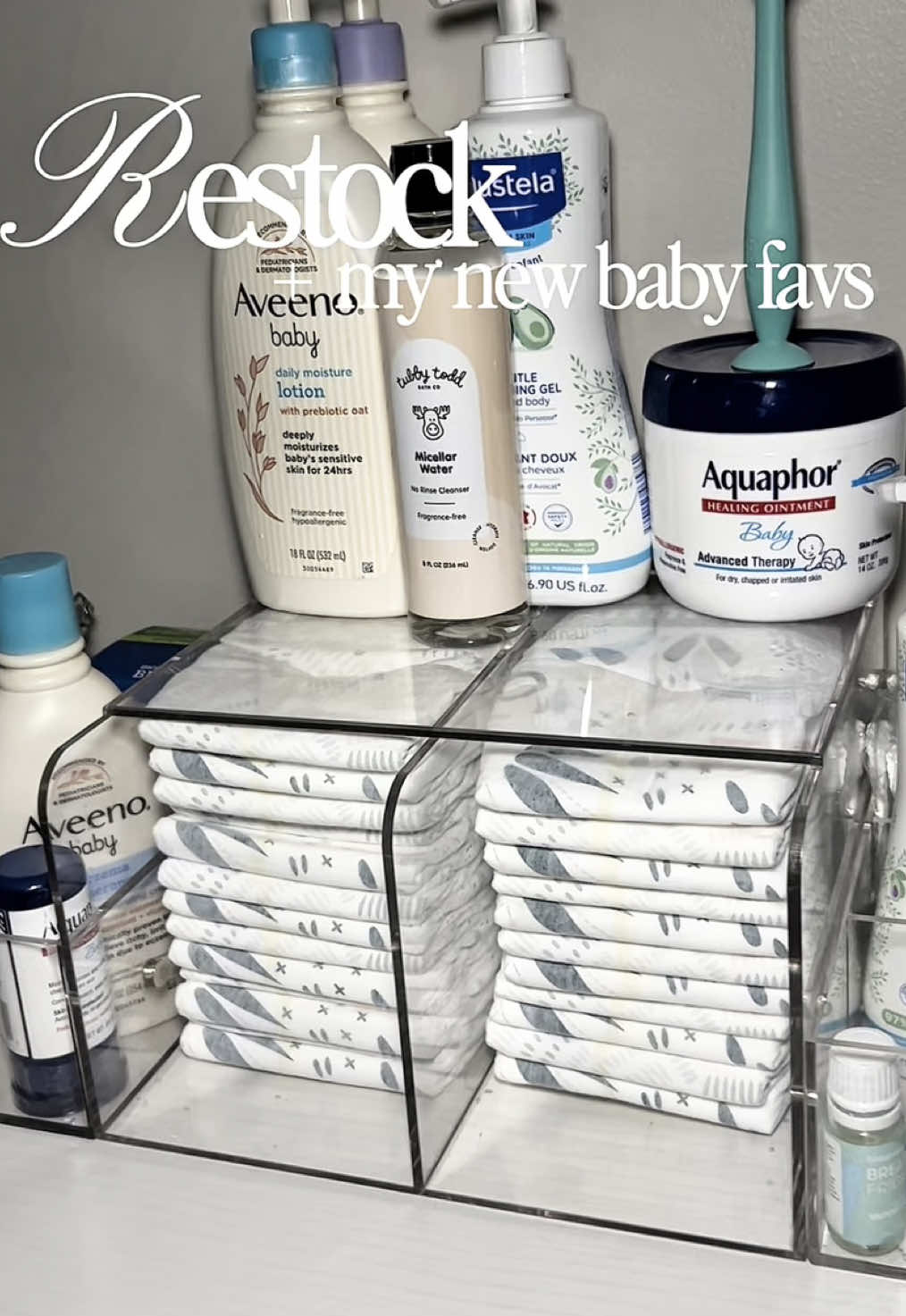 TikTok post by @nn.atalliee for Tubby Todd. Caption reads: Restock with me: acrylic diaper caddy edition + my....