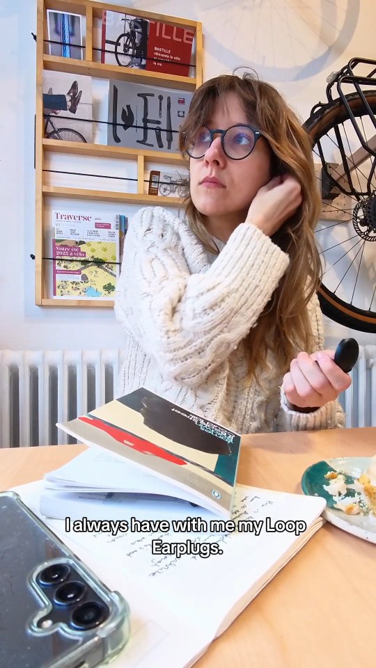 Instagram post by @emiliesliterarycorner for Loop Earplugs. Caption reads: Coffeeshop reads, @loopearplugs in, peace on....