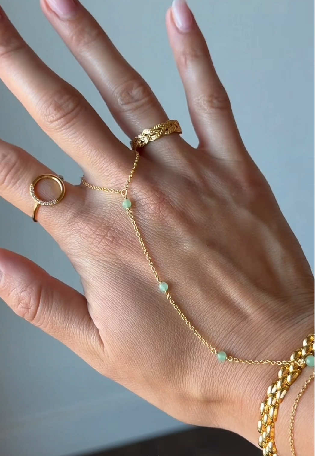 TikTok post by @dailywithveronica for Caitlyn Minimalist. Caption reads: [...] • Jade Hand Chain Bracelet @Caitlyn....