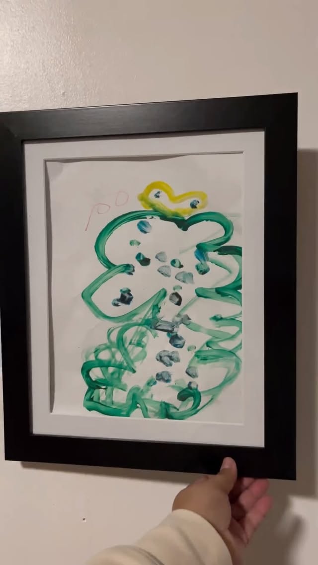 Instagram post by @vivacristina for Americanflat. Caption reads: The perfect way to display your little ones art....