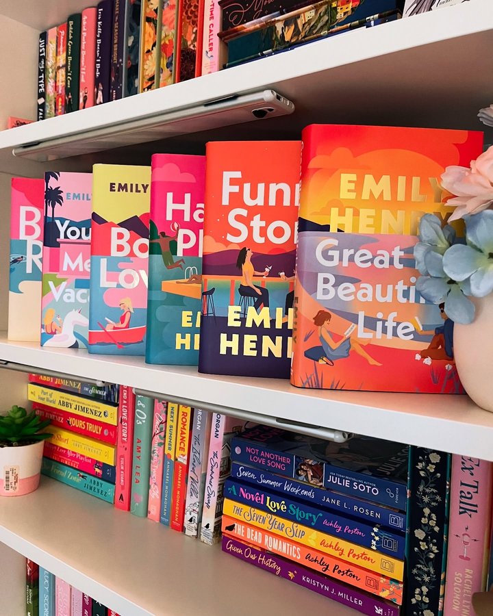 Instagram post by @lauralovesherbooks for Illumicrate. Caption reads: Sunday Summer Shelfie
@emilyhenrywrites....