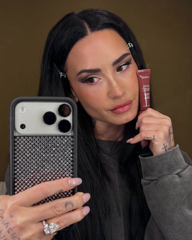 Instagram post by @ddlovato for LANEIGE. Caption reads: AD on set with @laneige_us Glaze Craze 💋....