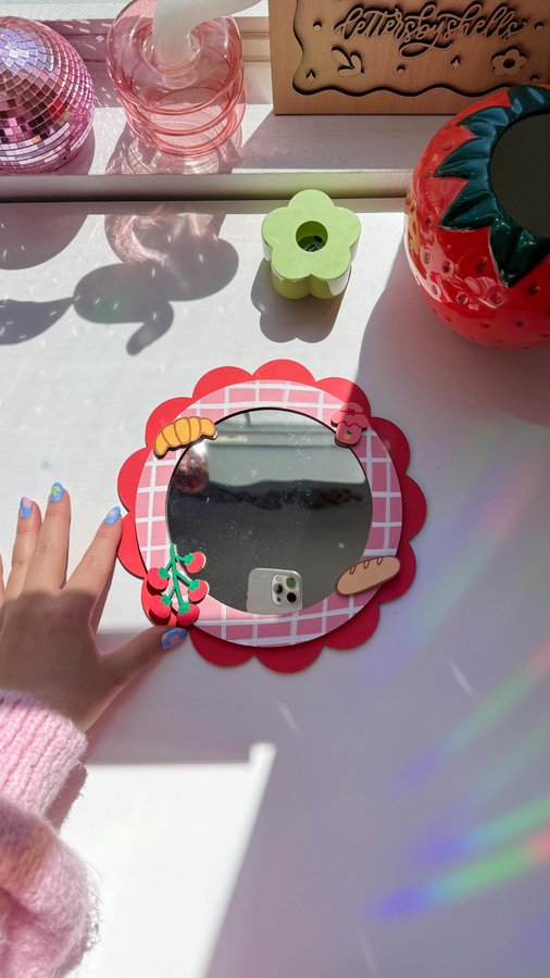 Instagram post by @lettersbyshells for Glowforge. Caption reads: my new fav mirror!! 🌷🪞🥖 made a 3D picnic-themed....